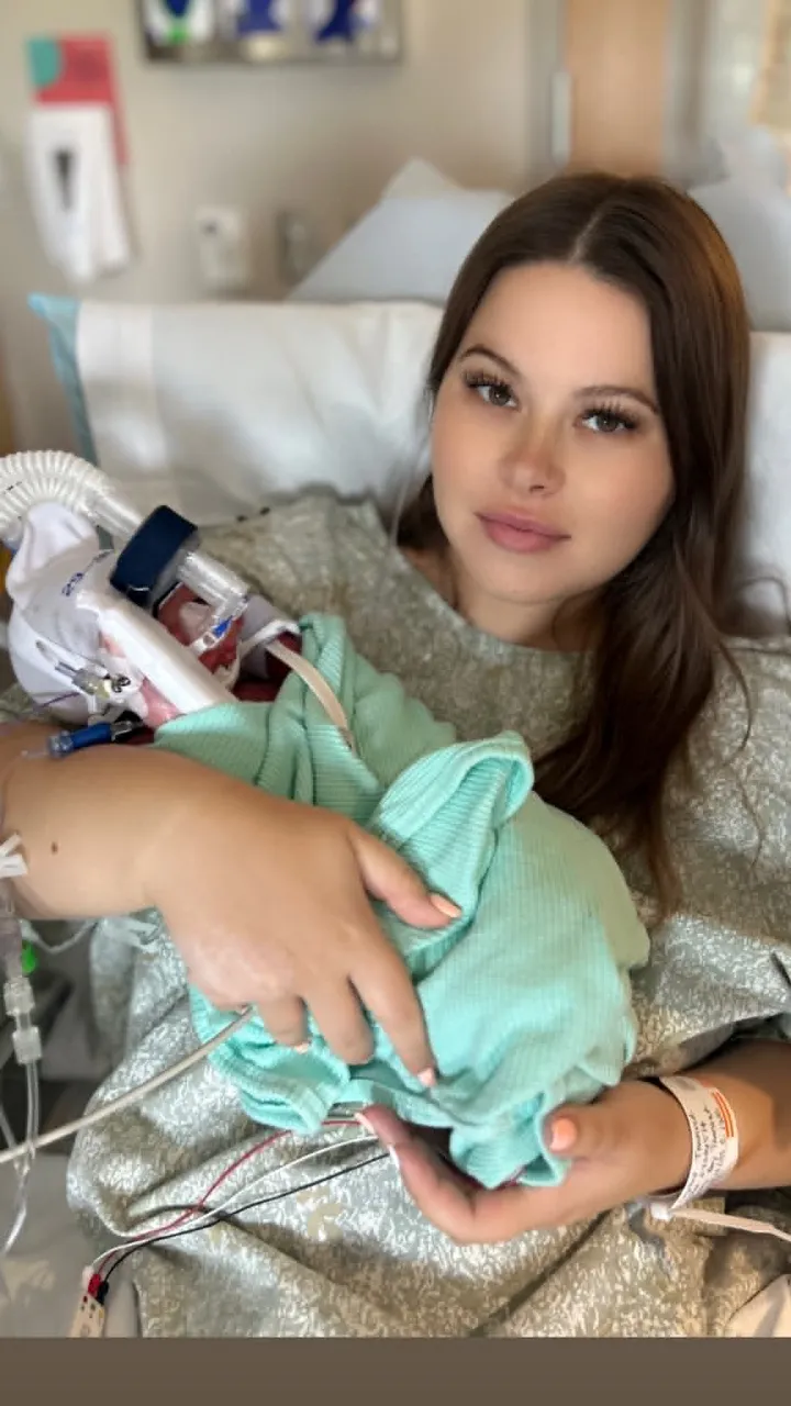 A mother holding her baby in the NICU